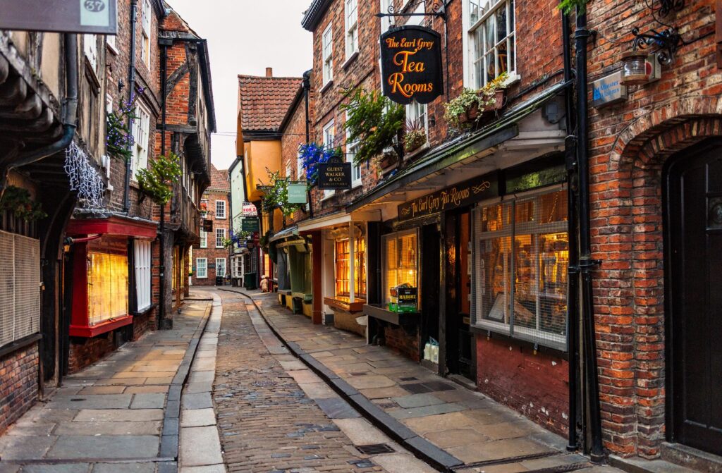 Cobbled stones and small shops with lanterns burning in a street, a suggestion in York on a day in the life of a travel concierge 
