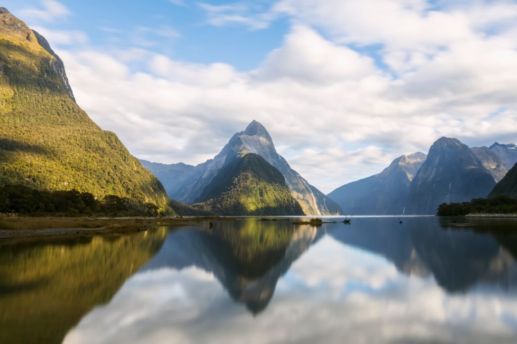 View of Milford Sound in New Zealand, vast waters with towering mountains.