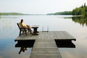 women relaxing on a lake dock in Finland, world's happiest country