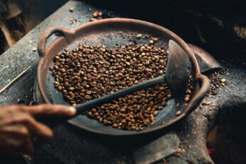 Traditional method of roasting coffee in a wok in Bali