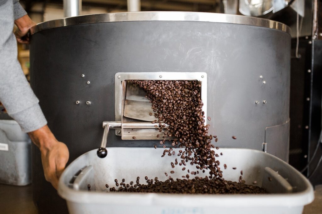 Coffee beans tumbling out of a roasting machine