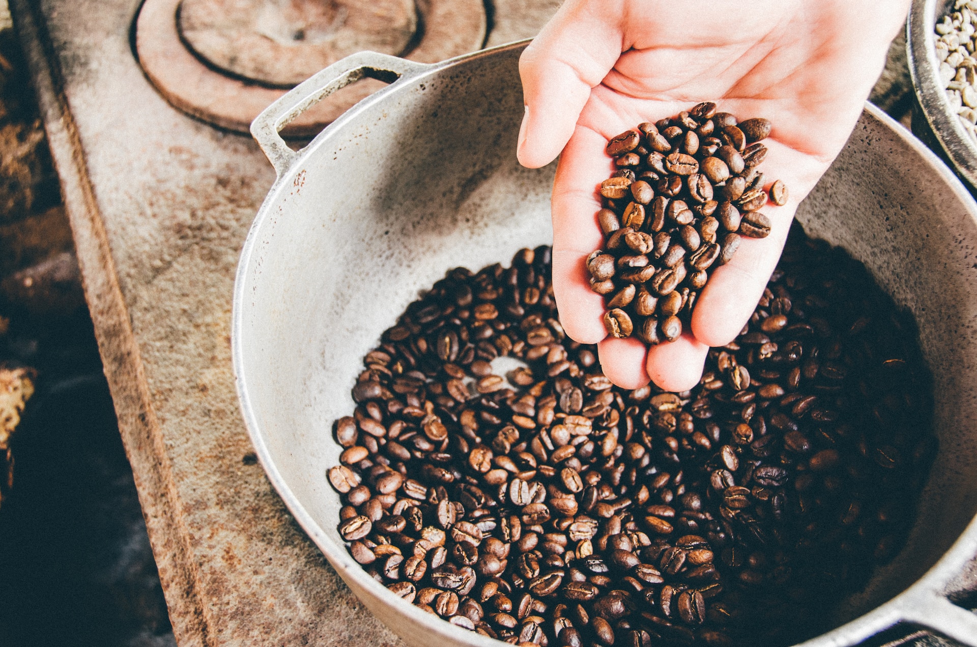coffee beans in pot being hand roasted