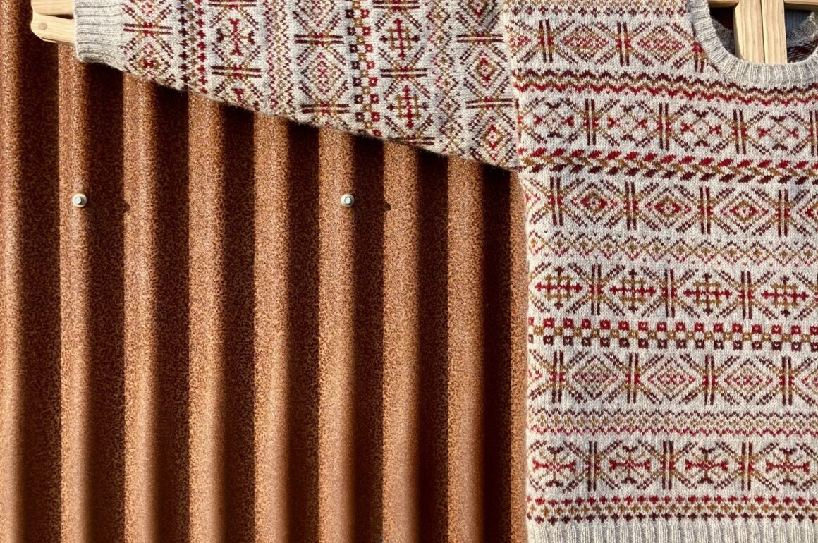 A Fair Isle sweater sits on a shaping rack
