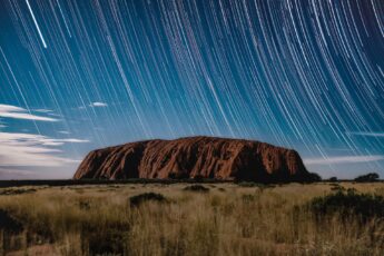 Uluru at night, starry sky blurred with long exposure effect