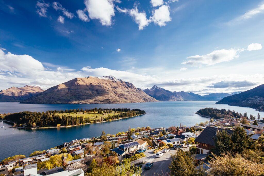 Birds Eye view of Queenstown in New Zealand with mountains, lakes and islands in the background.