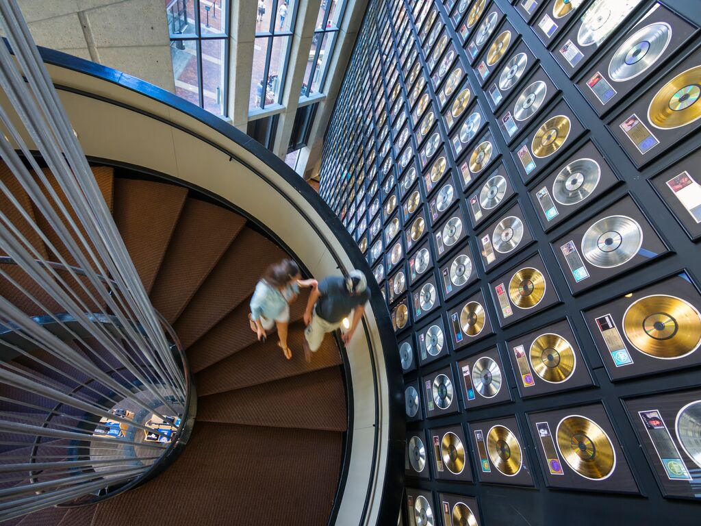visitors walking down a spiral staircase in the Country Music Hall of Fame