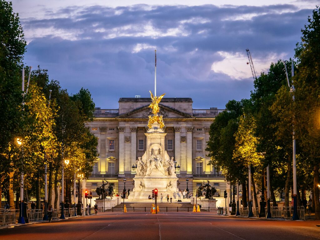 View looking down a wide pedestrianised street in low light towards a palace