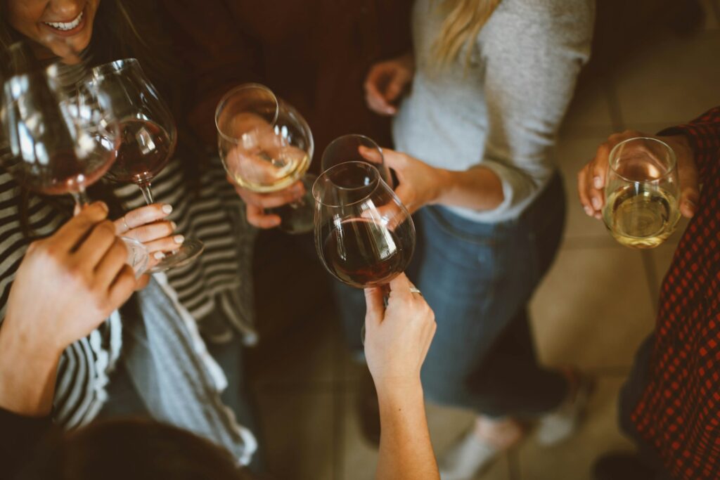 Group of young people clinking wine glasses