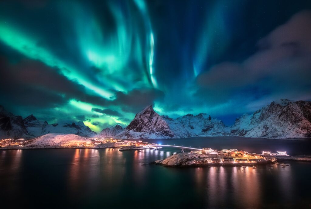 Northern lights dance above a town in Norway.