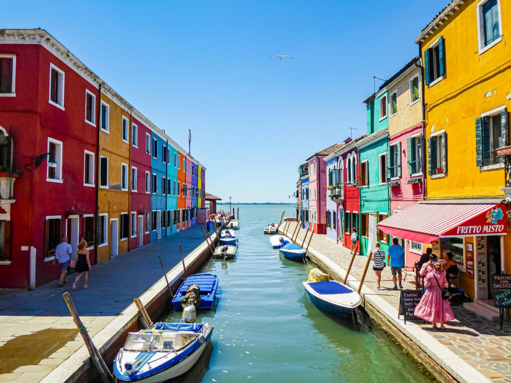 Coloured houses line the canal in Burano, Venice