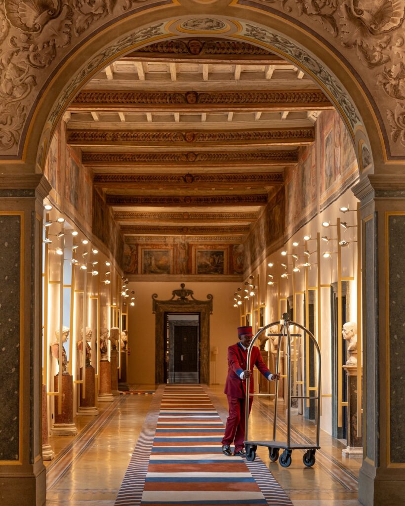 Interior of the Palazzo Talia lobby, with a bell-hop pushing a luggage trolley