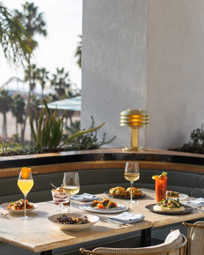 Breakfast set on an outdoor table with palm trees in the background