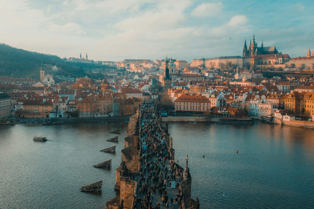 Aerial view of Bridge crossing river, many pedestrians, city skyline in distance