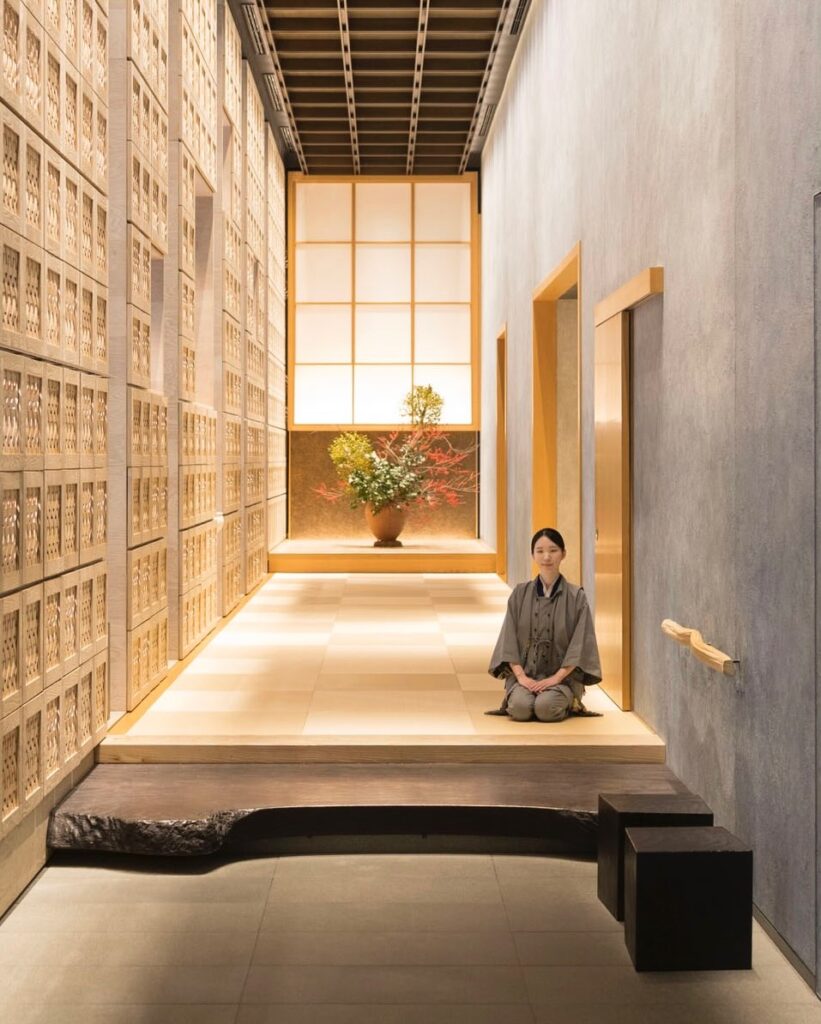 Woman kneeling in light and airy corridor