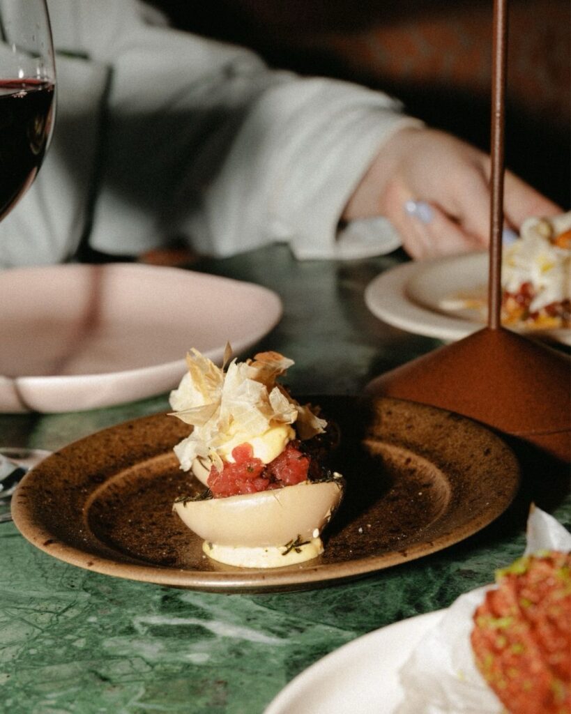 Plate of food on a green marble table at Santa Joana restaurant
