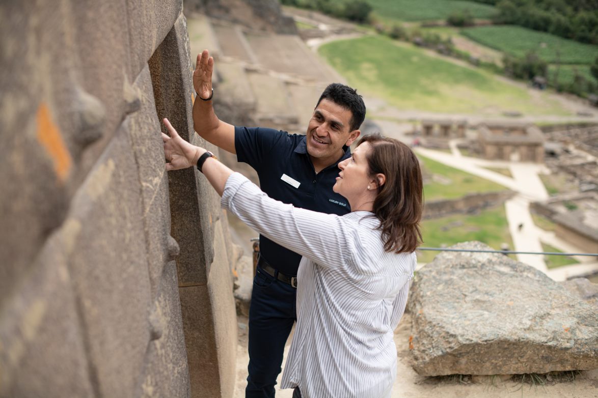 Tour Director And Tourists At Ancient Wall