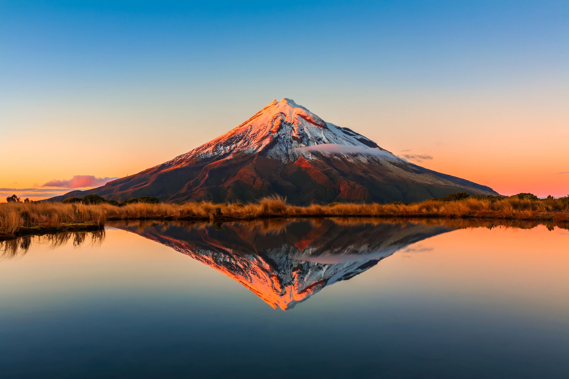 Mt Taranaki reflected in a lake in New Zealand
