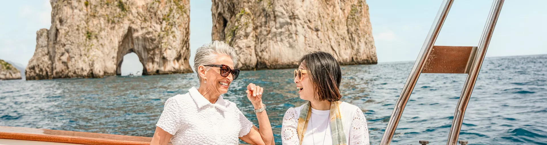 2 people laughing while on a private yacht in Capri, Italy