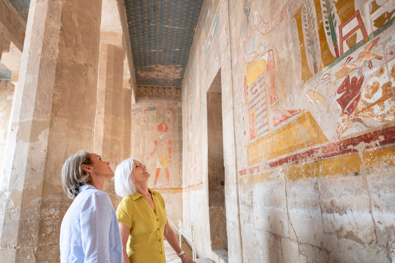 Women admiring ancient drawings on the walls, Giza, Egypt