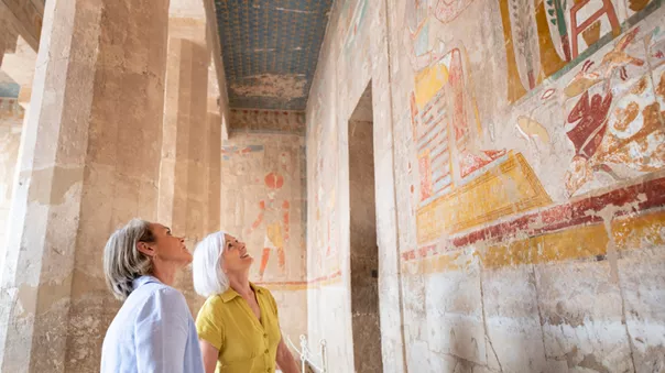 Women admiring ancient drawings on the walls, Giza, Egypt