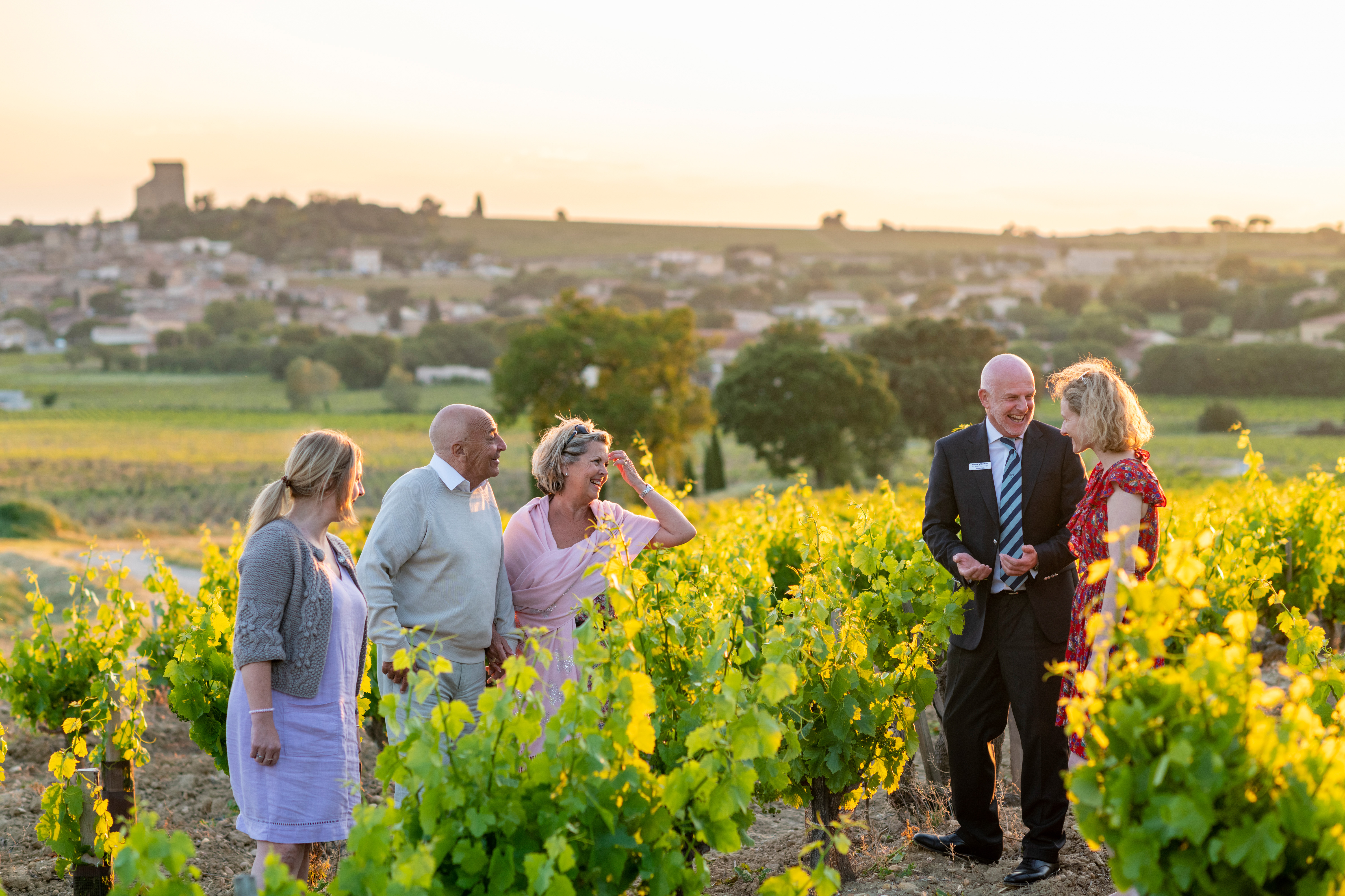 A group of people laughing on a yellow flowers field