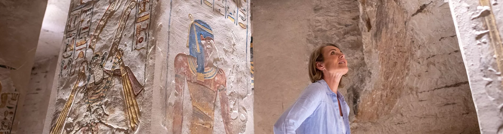 Woman gazing a hieroglyphics in Rameses VI Tomb in the Valley Of The Kings, Egypt