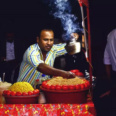 Man selling traditional street food in stand