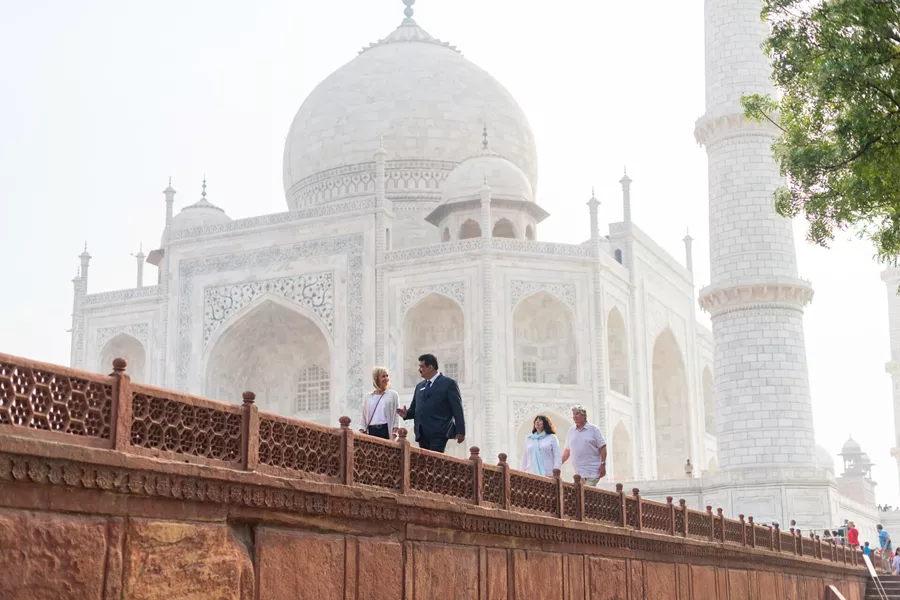 People strolling along Taj Mahal in India.