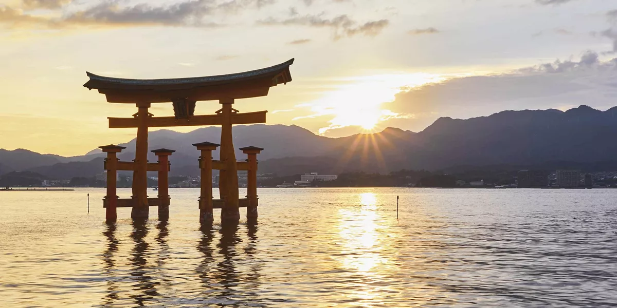 Torii gate at Itsukushima Shrine during sunset in Miyajima, Hiroshima, Japan