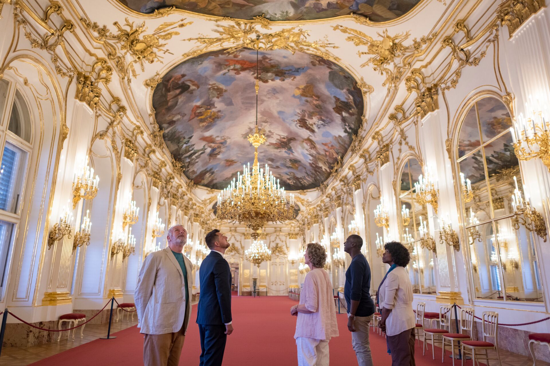 Travel concierge showing guests around Schönbrunn Palace in Vienna, Austria