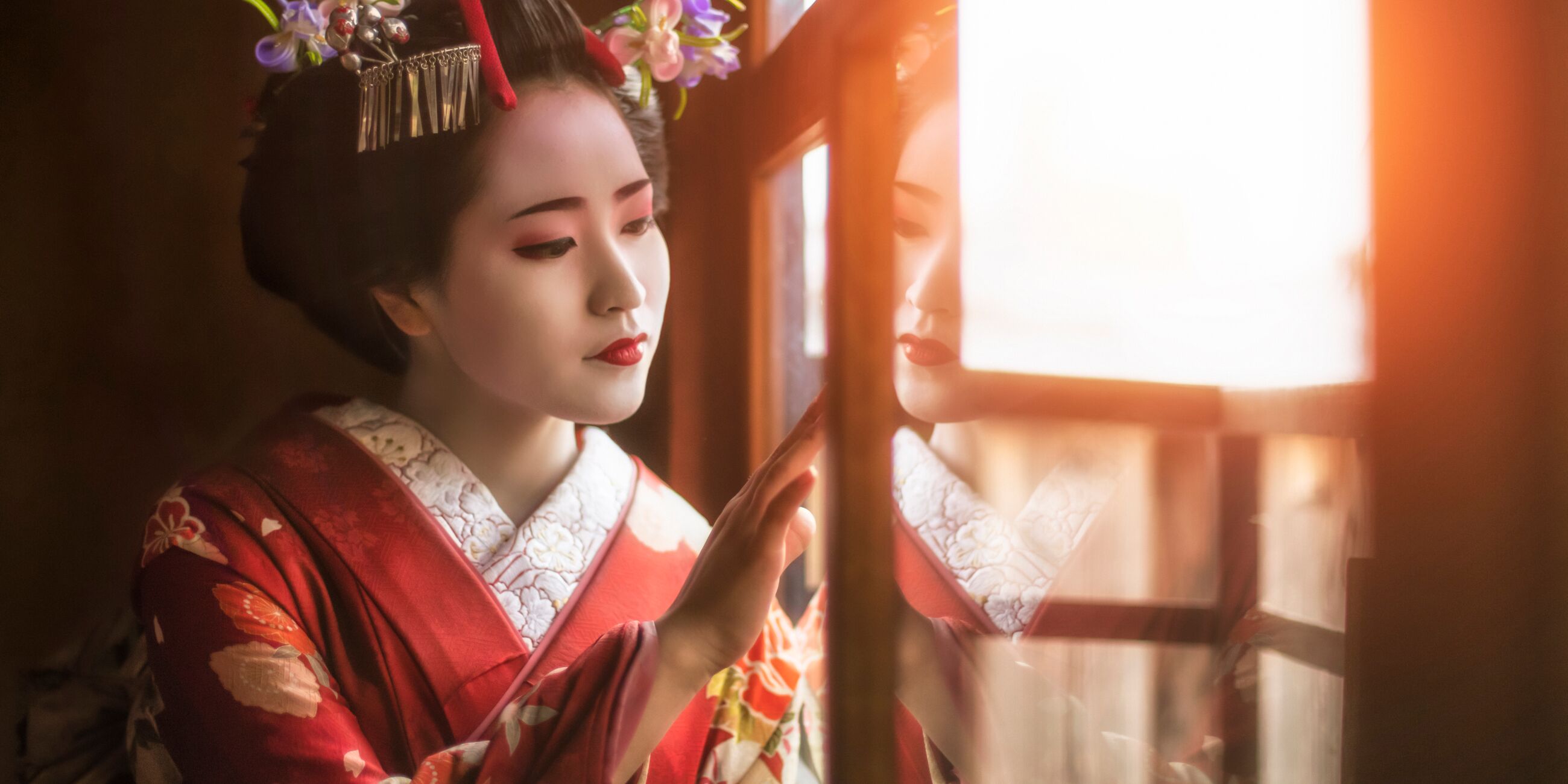 Geisha looking out of a window in Japan