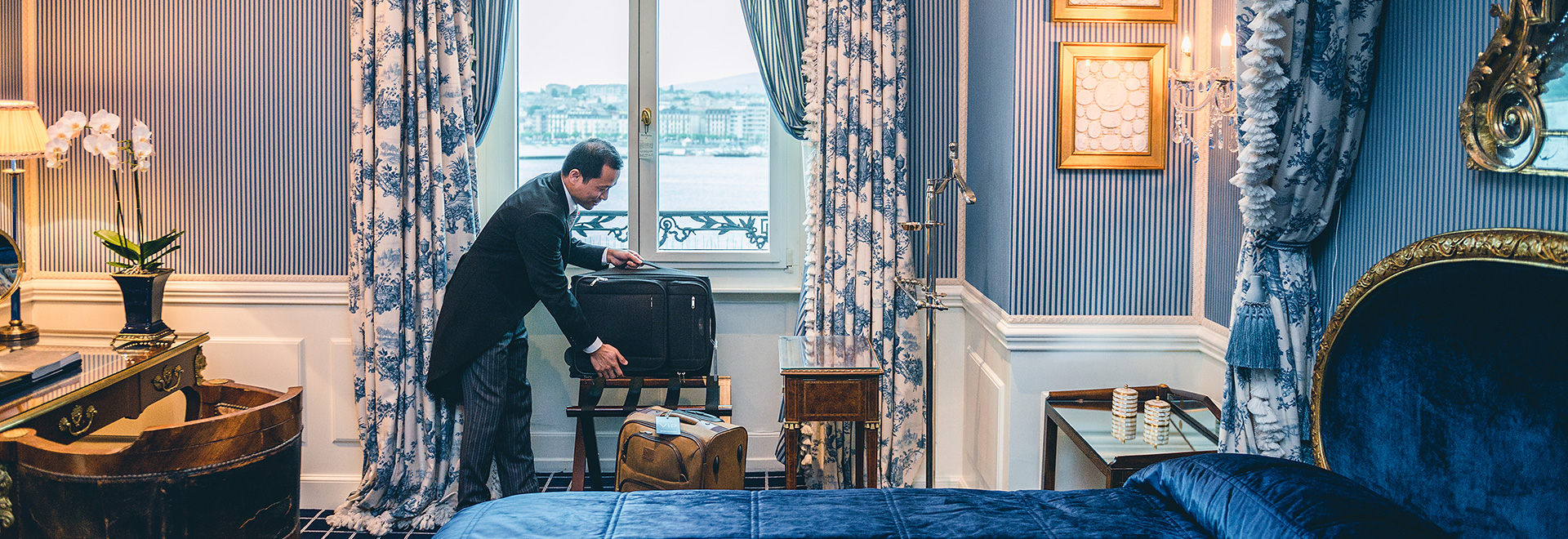 Man Packing Bags in Luxury Hotel