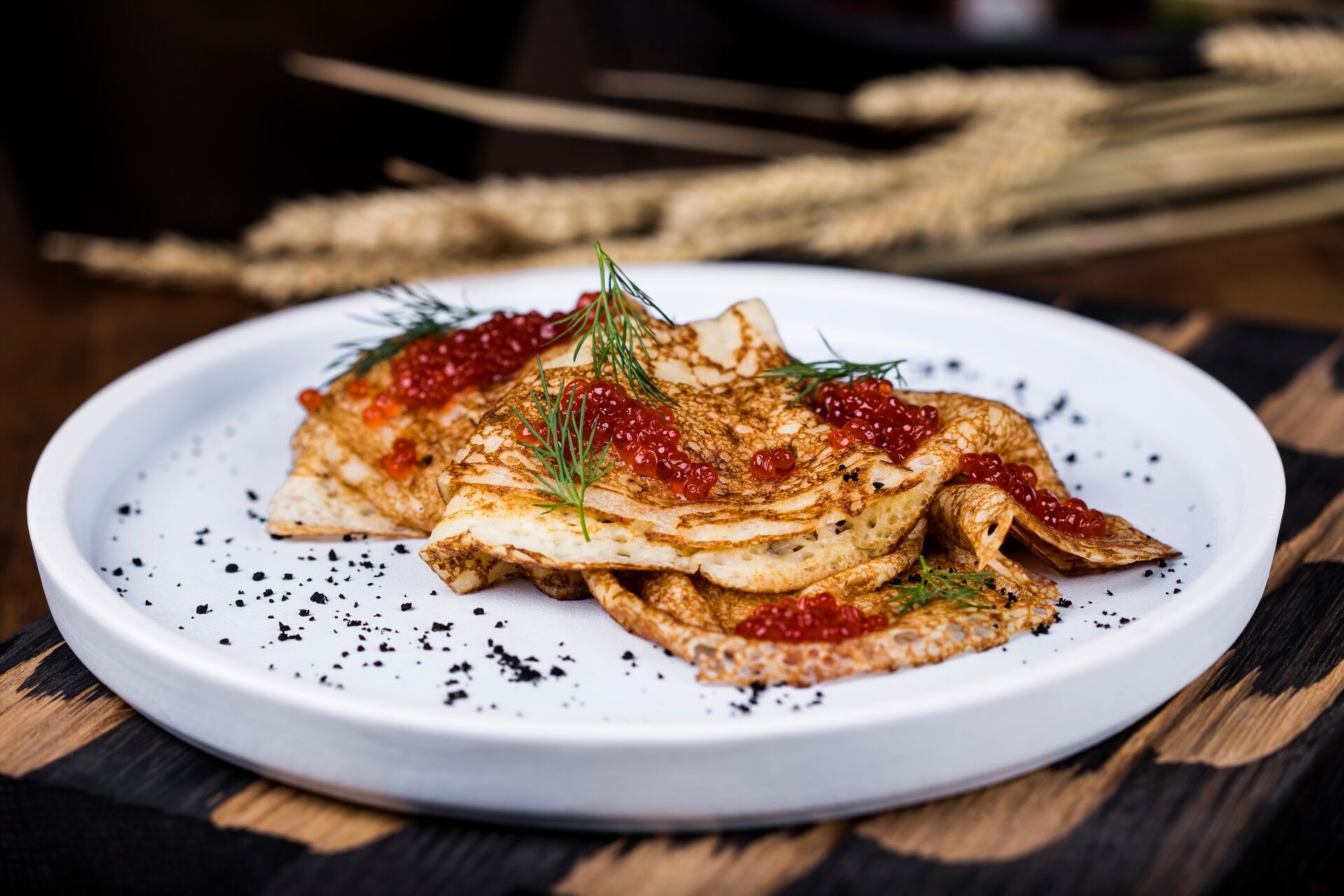Close up images of pancakes with salmon caviar