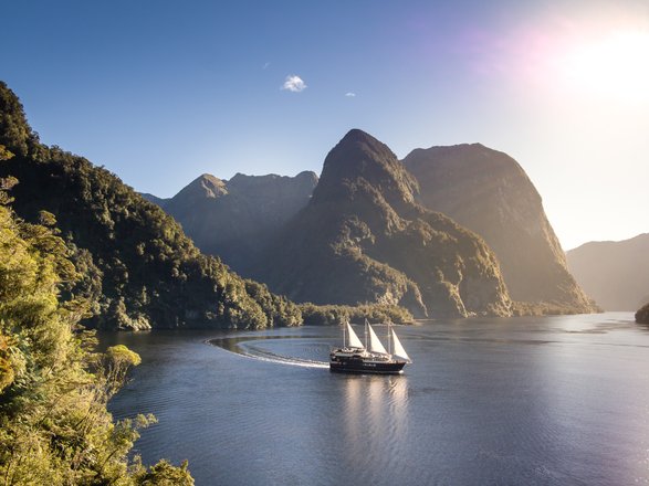 Sailing boat on Doubtful Sound in New Zealand at dusk
